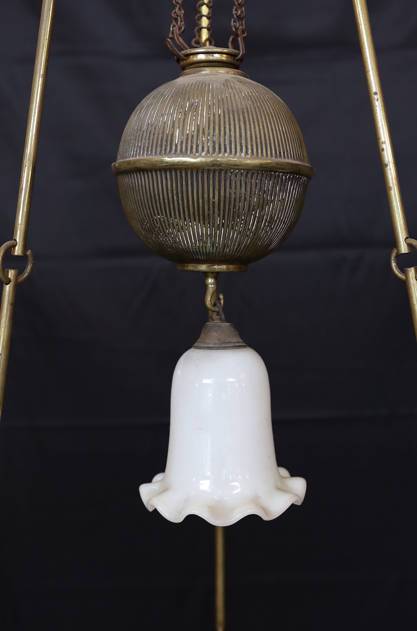 A Victorian Hinks brass counterbalanced hanging oil lamp with opaque glass shade and fluted balance weight, height 140cm, width 55cm
